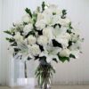10 White Carnations with 6 white roses and 2 stems of white lily